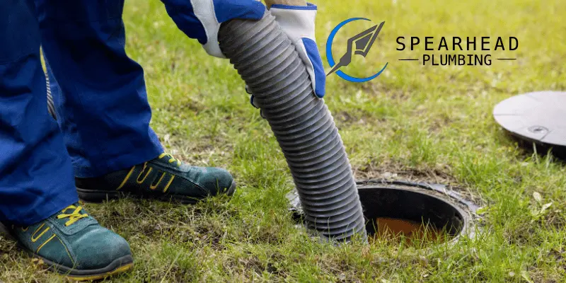 A plumber inspecting a septic system on a rural property in Augusta, MO.